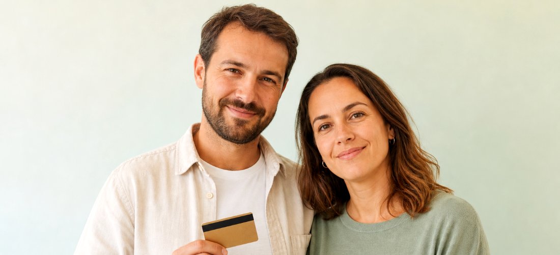 Couple who have got their debt under control, one holding a card